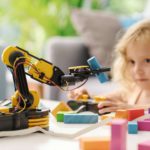 Child playing with a robotic arm toy