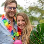 Cute young couple at tropical theme party