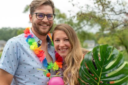 Cute young couple at tropical theme party