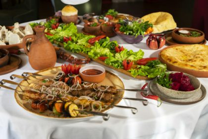 Georgian cuisine on a large laid table of different dishes for the whole family