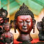 Goa, India. Traditional Store With Statues Different Colors And Sizes. Statues Of Buddha Head And
