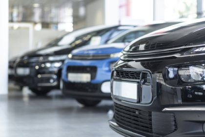 Low angle of extravagance store with cars in a row for sale