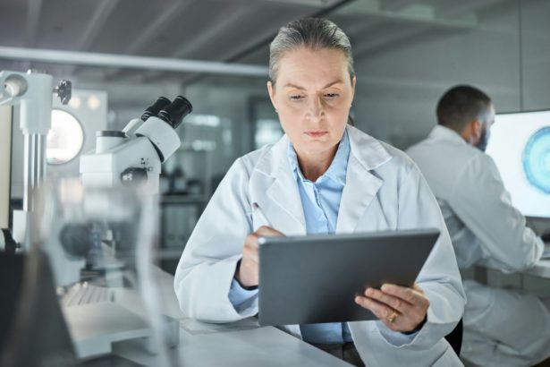 Science, tablet and innovation with a woman engineer doing research in a medical laboratory. Analyt
