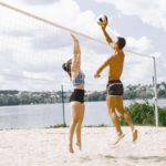 Young people playing volleyball on the beach