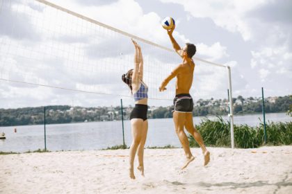 Young people playing volleyball on the beach